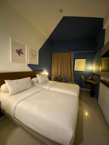 a large white bed in a hotel room at Ispi Hotel Cikarang Festival in Serang +23 photos