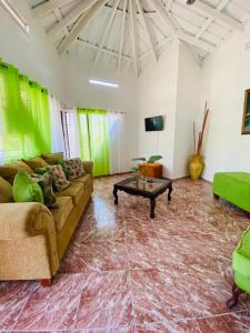 a living room with a couch and a table at Villa Marcia in Boca Chica