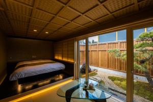 a bedroom with a bed and a glass table at HOTEL ZEN-Adult Only in Hirosaki