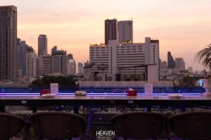a view of a city skyline from a table with chairs at Heaven Boutique Hotel in Bangkok