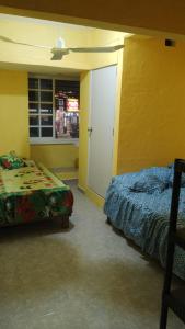 a bedroom with a bed and a door and a window at El Rincón del Ángel Tuxpan in Tuxpan de Rodríguez Cano +31 photos