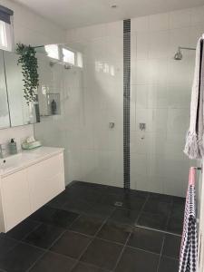 a bathroom with a shower and a sink at Entire contemporary home in Ascot Vale in Melbourne