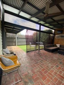 a patio with awning and chairs and a table at Entire contemporary home in Ascot Vale in Melbourne