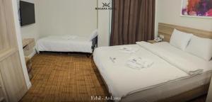 Ліжко або ліжка в номері Niagara Hotel Erbil