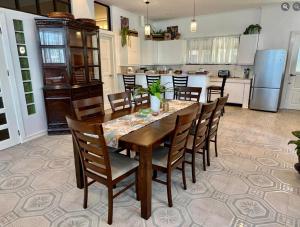 a kitchen with a dining room table and chairs at Big & Homey in exclusive village in Davao City