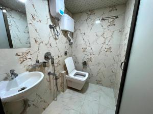 a bathroom with a sink and a toilet at Hotel Belmond Prime- Near NESCO in Mumbai