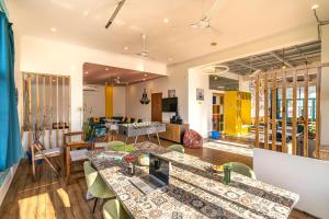 a living room with a table and chairs at The Hosteller Rishikesh, Upper Tapovan in Rishīkesh