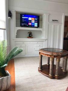 a living room with a table and a tv at Misha’s Cozy Rare 3brm in Marysville