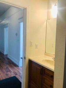 a bathroom with a sink and a mirror at Misha’s Cozy Rare 3brm in Marysville