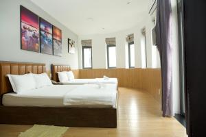 Postel nebo postele na pokoji v ubytování HAPPY HOTEL Tp Rạch Giá, Kiên Giang