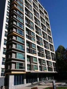 a tall apartment building with many windows at Beijing Yasmine Seasons Park Apartment Hotel in Beijing