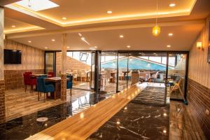 a lobby of a hotel with tables and chairs at Deryaman Hotel Trabzon in Trabzon