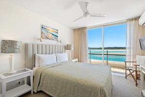 a bedroom with a bed with a view of the ocean at Las Rias Holiday Apartments in Noosa Heads +118 photos