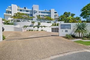 a large white building with a sign in front of it at Las Rias Holiday Apartments in Noosa Heads