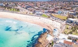 an aerial view of a beach with a group of people at Spirit of Bondi Apartments in Sydney