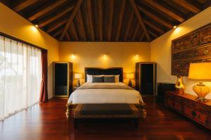 a bedroom with a large bed and a large window at GLAMDAY VILLA OKINAWA NAKAMURATEI in Meta