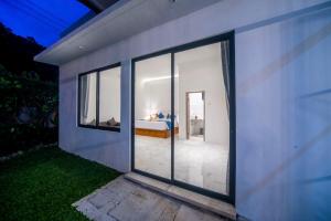 a view of a bedroom from the outside of a house at Villa Sayang Sanur 111 in Sanur