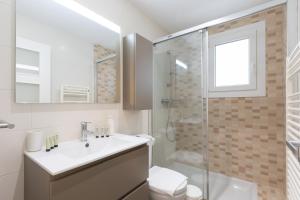 a white bathroom with a sink and a shower at Artabide - Baskeyrentals in Ondárroa