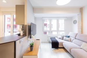 a white living room with a couch and a table at Artabide - Baskeyrentals in Ondárroa