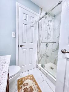 a bathroom with a shower and a toilet at Luxurious Renovated Rooms in Central Vaughan in Vaughan