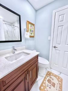 a bathroom with a sink and a toilet at Luxurious Renovated Rooms in Central Vaughan in Vaughan