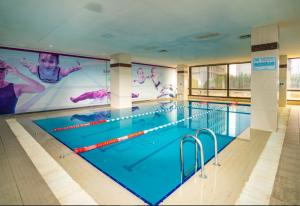 a swimming pool with a large screen in a building at Anemon Eskisehir Hotel in Eskisehir