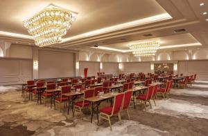 a banquet hall with tables and chairs and chandeliers at Anemon Eskisehir Hotel in Eskisehir