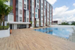a swimming pool in front of a building at RedLiving Apartemen Barsa City by Ciputra - WM Property in Yogyakarta