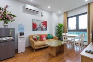 a living room with a couch and a table at Granda Quan Hoa Apartment in Hanoi