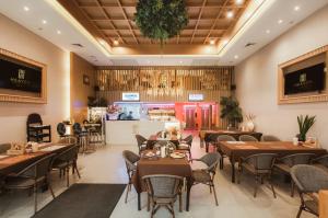 a restaurant with tables and chairs and a counter at Heaven Boutique Hotel in Bangkok