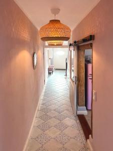 a hallway with a tile floor and a chandelier at Kleinstadtidyll Plau am See in Plau am See