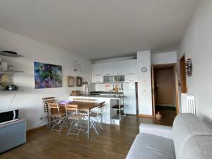 a kitchen and living room with a table and chairs at Casa Bella Vista- Punta Gaeta San Siro CO in San Siro