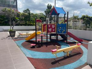 a playground with a slide on a roof at Premium Service Appartment in Seri Kembangan