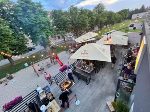 an overhead view of a market with tables and umbrellas at Dubno Eat & Sleep in Nová Dubnica