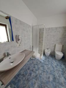 a bathroom with a sink and a toilet at Butterfly in Bagnoregio