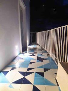 a balcony with a black and white tiled floor at La Pigolina in Positano