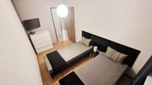 シュクラルスカ・ポレンバにあるApartament Zakątek - Centrumのベッド1台とテレビが備わる小さな客室です。