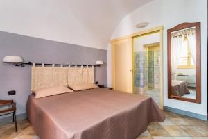 En eller flere senge i et værelse på Locanda di Corte