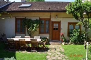 a table and chairs in front of a house at B&B Chez Marie in Beaune