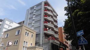 a tall building with balconies on the side of it at lineweb Home sapporo803 in Sapporo