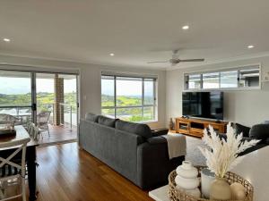 a living room with a couch and a table at Hillston House in Kiama