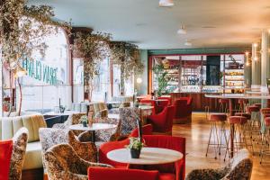 a restaurant with tables and chairs and a bar at Iberostar Las Letras Gran Via in Madrid