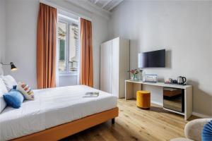 a hotel room with a bed and a tv at Dimora72 Luxury Rooms in Florence +21 photos