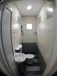 a small bathroom with a sink and a toilet at AVENUE HOMESTAY 5 Room 4 Toilet 4 MINUTES TO TOWER in Teluk Intan