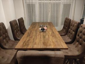 una mesa de madera con sillas de cuero alrededor en Hello Home, en Pelling