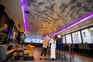 a bride and groom pose for a picture in the restaurant at The Royal Park Canvas - Osaka Kitahama in Osaka