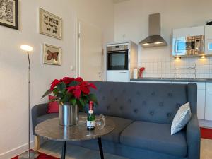 een woonkamer met een blauwe bank en een tafel bij Villa Anna App. 7 Seeblick in Heringsdorf