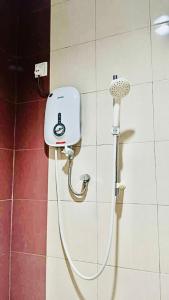 a shower with a blow dryer in a bathroom at Baron Water Front in Kuah