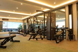 a gym with cardio equipment in a building at Rizal Park Hotel in Manila