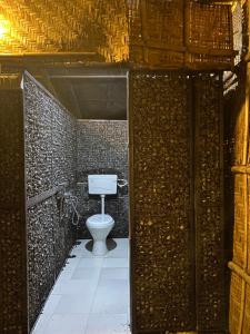 a bathroom with a toilet in a brick wall at Mystic Hive in Pushkar